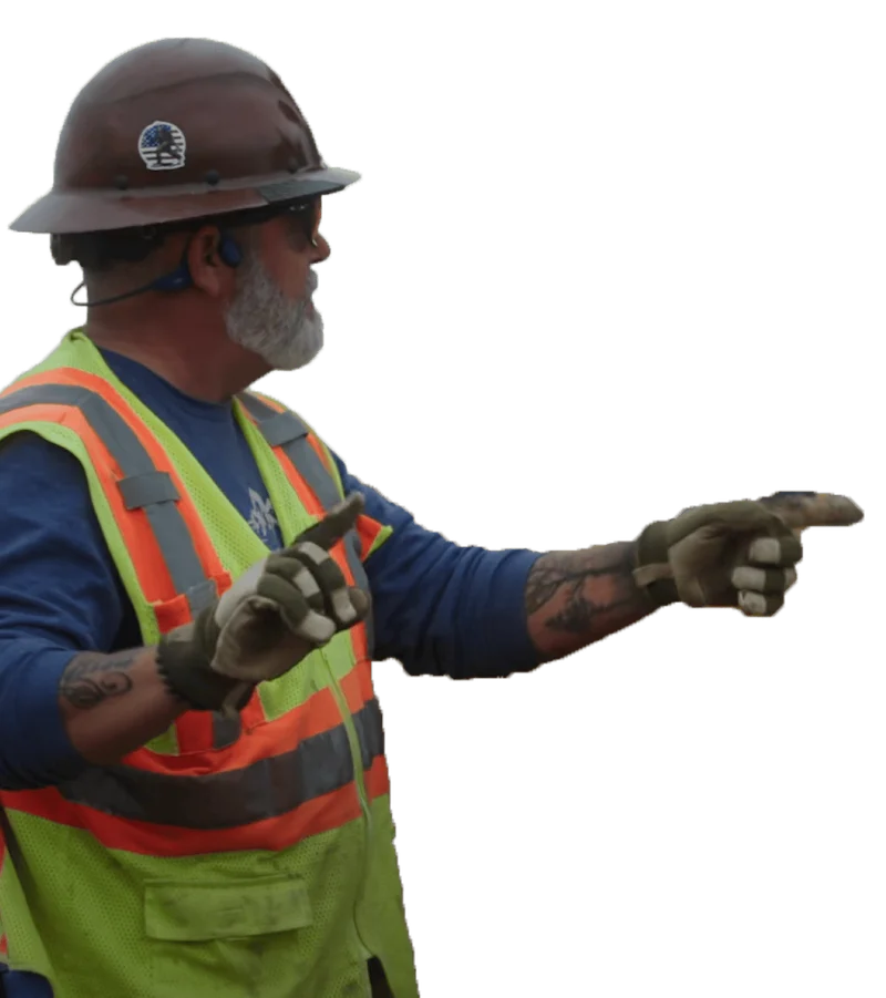 construction worker pointing at worksite